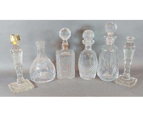 A cut glass decanter with Birmingham silver collar together with a Waterford glass decanter, two other glass decanters and a 