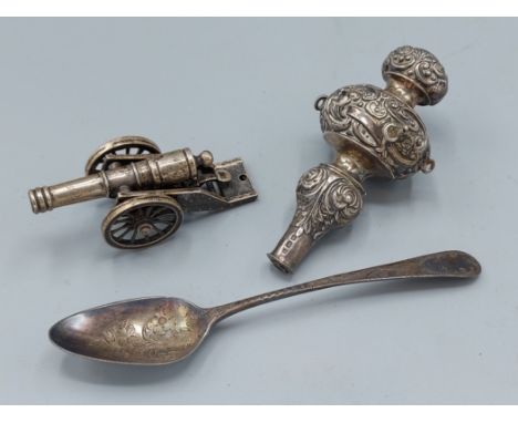 A 925 silver model of a cannon and carriage, 6cm long together with a Birmingham silver babies rattle and a Georgian silver t