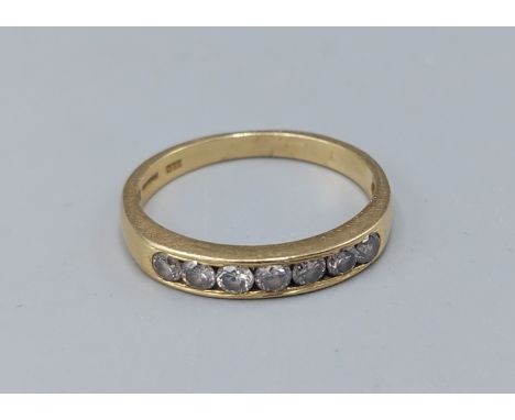 An 18ct gold Diamond band ring set with seven Diamonds, 3gms, ring size P