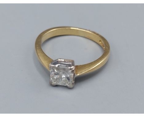 An 18ct gold solitaire Diamond ring set with princess cut Diamond within a pierced setting, 2.4gms ring size H