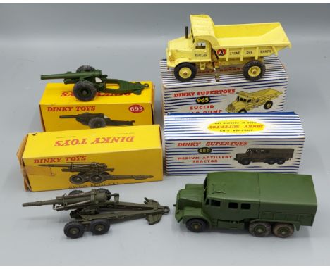 A Dinky Supertoys Dump Truck number 965 together with another Artillery Tractor number 689, another Obusier number 80E and Ho