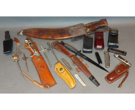 A Commando knife with leather sheath together with a Kukhri knife and various multi tools and related to include Leathermans 