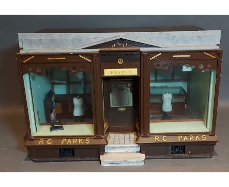 An early 20th Century model of a shop front, R. C. Parks, Draper with contents, 49cms wide