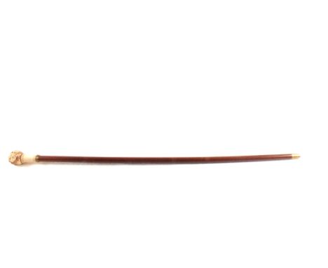 A walking stick with a decorative top