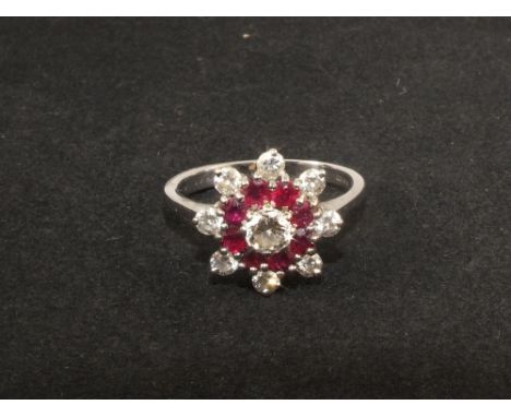 An 18ct white gold ruby and diamond cluster ring, size N