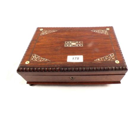 A 19th Century rosewood and mother of pearl inlaid games box with mother of pearl inlaid crib board, bezique counters and car