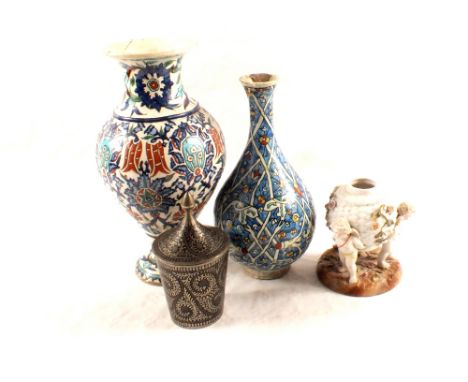 A Sitzendorf porcelain cherub lamp base, two Persian vases (as found) plus a metal lidded pot