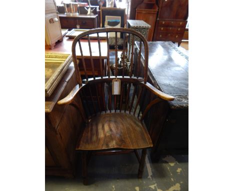 A late 19th Century Windsor elm and beech comb back elbow chair.