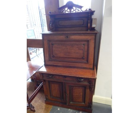 A late 19th Century continental oak and burr oak secretaire cabinet with raised shelf back over a panelled frieze drawer and 