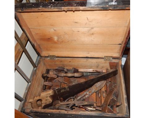 A carpenter's tool trunk, the pine chest containing various moulded, shooting and smoothing planes, also including a panel sa