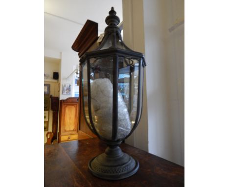 A verdigris metal glazed octagonal lantern with tea light interior, H. 72cm.