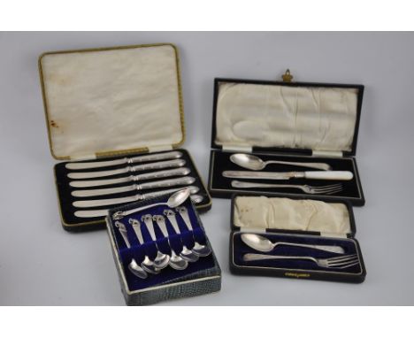 A George V cased silver spoon and fork, together with seven Siam sterling silver spoons, a case set of silver handled tea kni