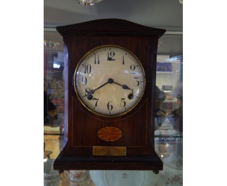 An Edwardian mahogany eight day mantel clock with circular white dial marked Arabic numerals, together with a later walnut ca