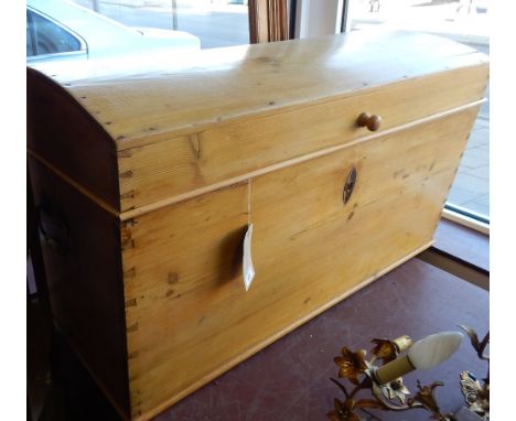 A 19th Century pine domed top trunk with wrought iron side handles and interior candle box. W. 112cm