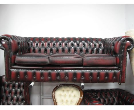 An Ox Blood Leather Button Back Chesterfield Three Seater Settee. 