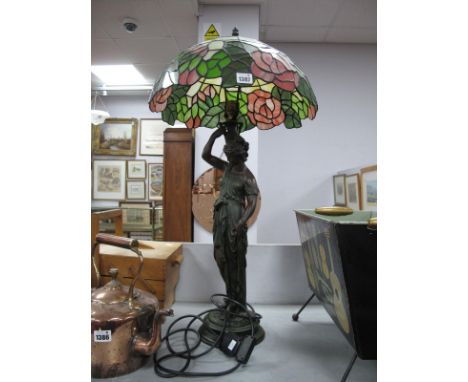 A Tiffany Style Table Lamp, with traditional shape, supported by maiden, on circular base.