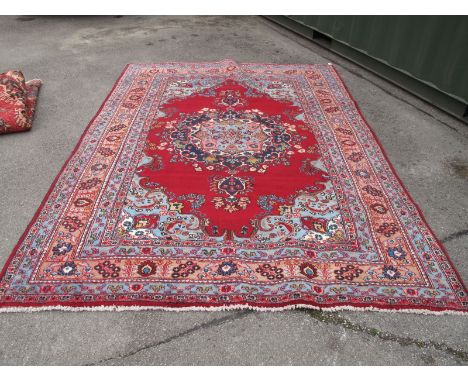 A Vintage Iranian Mashad Region Carpet, with traditional medallion design on a claret ground, no visible wear or tears, 198 x