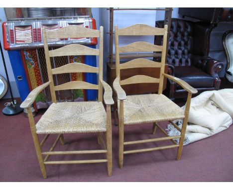 A Pair of Ash Ladder Back Armchairs, with rushed seats, on circular legs united by stretchers. (2)