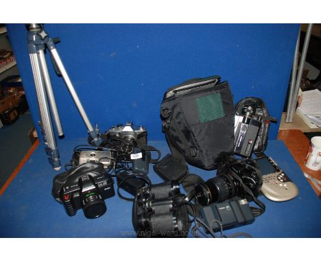 A quantity of Cameras and a tripod in a bag.