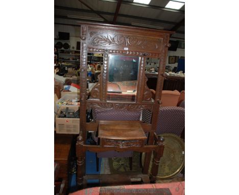 A 19th c. Oak Hall Stand, having carved back with central rectangular bevel plate mirror in fret-cut carved frame, having tur