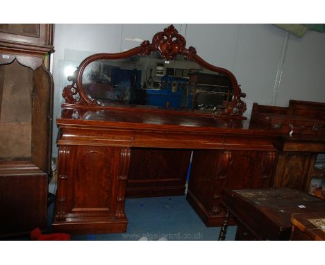 A superb Victorian Mahogany mirrorback Sideboard, having ornate shaped mirror in moulded frame with central carved scrolls an