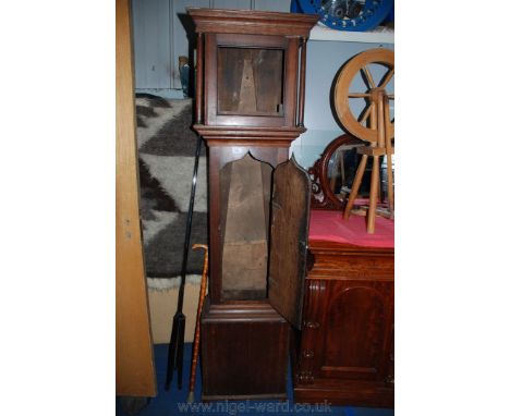 An early 19th c. Oak longcase clock Case having moulded cornice to the hood, square door flanked by turned pillar supports wi