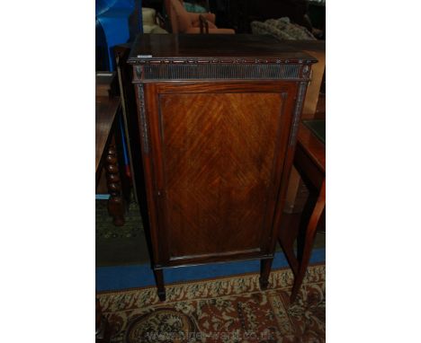 An Edwardian Mahogany Cabinet, having moulded edge rectangular top over reeded frieze, over single panel 1/4 veneered door op