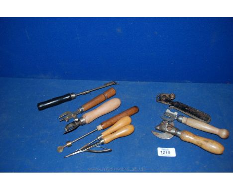 A box of six vintage can openers, tools, etc.