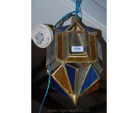 A decorative glass lantern with clear, yellow and blue glass