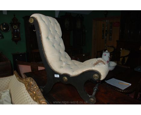 A late Victorian ebonised Empire style Nursing Chair, having gilt trim to the back supports and brass rosette detail, button 