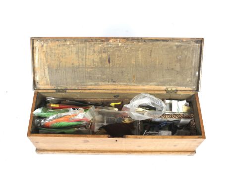 An extensive collection of fly-tying equipment and materials. Including capes, feathers, hooks, threads and tools in a wooden