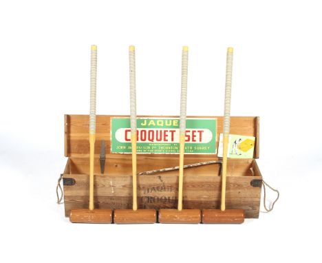 A John Jacques croquet set in box. Comprising four mallets, hoops, balls and instructions, etc. 