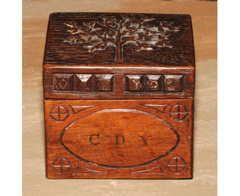 An Arts and Crafts oak rectangular box or caddy, the hinged cover carved with a stylised apple tree, 10.5cm wide, c.1910 