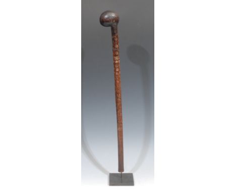 Tribal Art - an African rungu type throwing club, the offset bulbous head with central ridge, the shaft incise-carved with ge