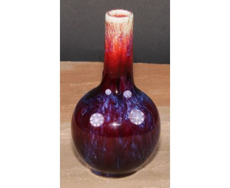 A Chinese monochrome ovoid vase, glazed in mottled tones of peach and purple, 13cm high, seal mark 