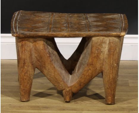 Tribal Art - a Nupe stool, the rectangular top carved with geometric motifs, 30cm high, 48cm wide, Central Nigeria 