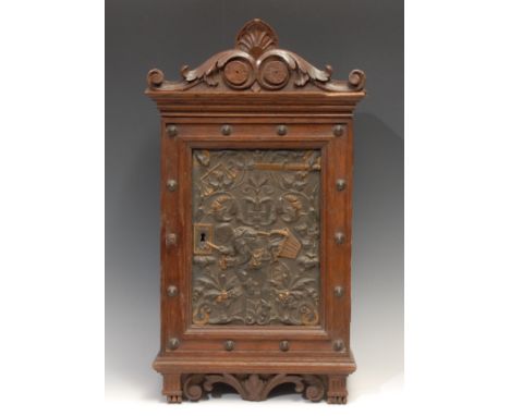 A 19th century Continental oak wall hanging hall cabinet, in the Renaissance Revival taste, shaped apron above a door enclosi