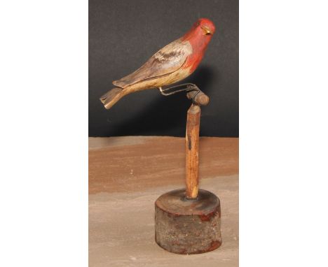 Folk Art - a soft wood avian model, carved and painted as a bird on a perch, 21cm high 