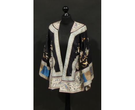 A late 19th/early 20th Century Chinese silk jacket, embroidered panel, fanciful bird, butterflies, flowers on deep blue groun