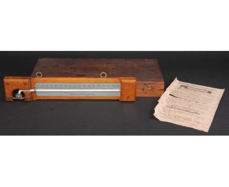 A Negretti &amp; Zambra minimum self-registering thermometer, silvered register, oak mount, 35.5cm long 