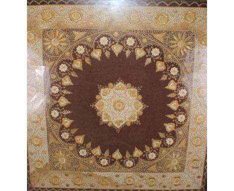 An Indian textile panel, worked in gilt and silvered threads, on a crimson ground, 83cm x 80cm, gilt frame 