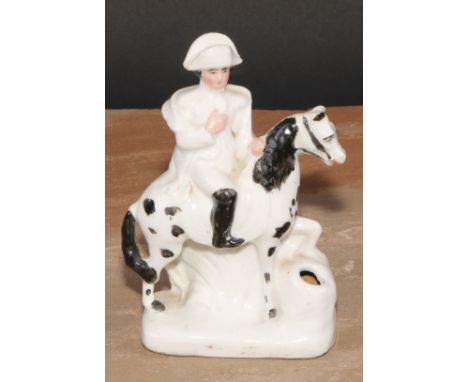 A late 19th century German porcelain inkwell, of fairing type, modelled as Napoleon Bonaparte on horseback, 13.5cm high, c.19