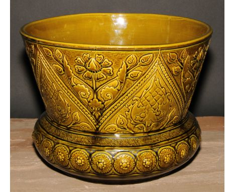 A Burmantofts Aesthetic Movement art pottery jardiniere, moulded with stylised flowers, glazed in mottled tones of green, 21.