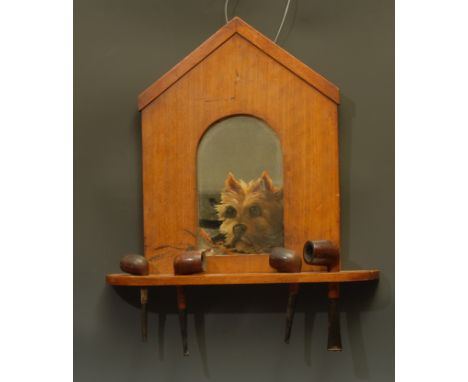An early 20th century mahogany novelty hall pipe pipe rack, as a dog kennel, the arched mirror painted with a terrier, above 
