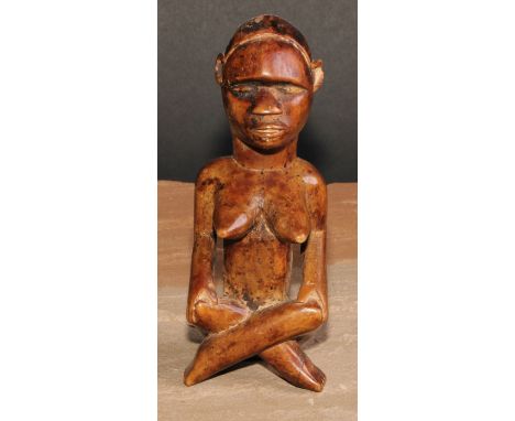 Tribal Art - an African female figure, seated, cross-legged, 15cm high 