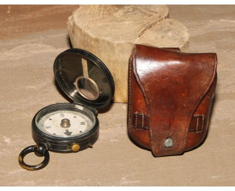 An early 20th century brass compass, probably military, 8cm over loop, leather case 