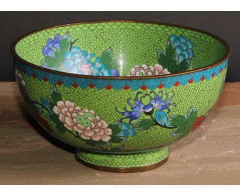 A Japanese cloisonne enamel circular pedestal bowl, decorated in polychrome with flowering stems on a green ground, 23cm diam