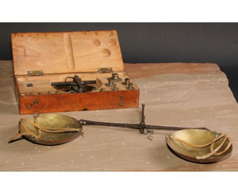 A set of early 20th century iron and brass balance scales, the weights to 200 grammes, the beam 25cm long, fitted beech box, 