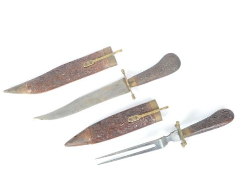 A set of two 20th century Indian hardwood &amp; brass carving knives. The set including a carving knife &amp; fork having int