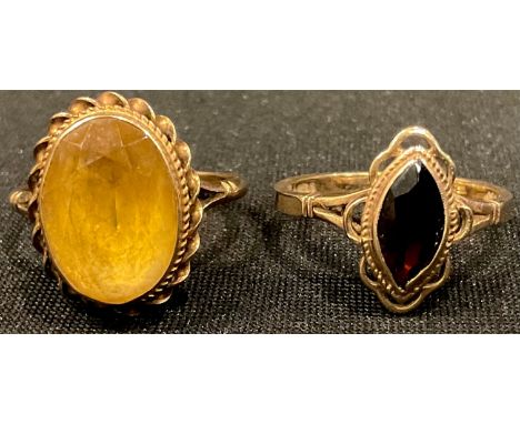 A 9ct gold garnet ring, size P/Q, 2.8g; a 9ct gold citrine ring, size P/Q, 3.7g (2) 